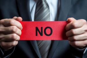 Person holding red No sign