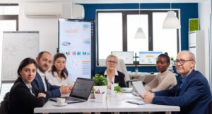 Diverse compliance team in a conference room discussing integrated KYC and AML workflow strategy for mid-market Japanese financial institutions