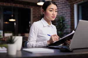 Financial advisor reviewing updated FSA AML/CFT guidelines and compliance paperwork for Japanese financial institutions