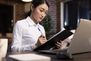 Compliance officer reviewing PEP screening documentation and FSA obligations for Japanese financial institutions