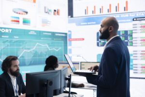 Compliance team assembling in a data room to review transaction monitoring system performance and AML detection data for Japanese institutions
