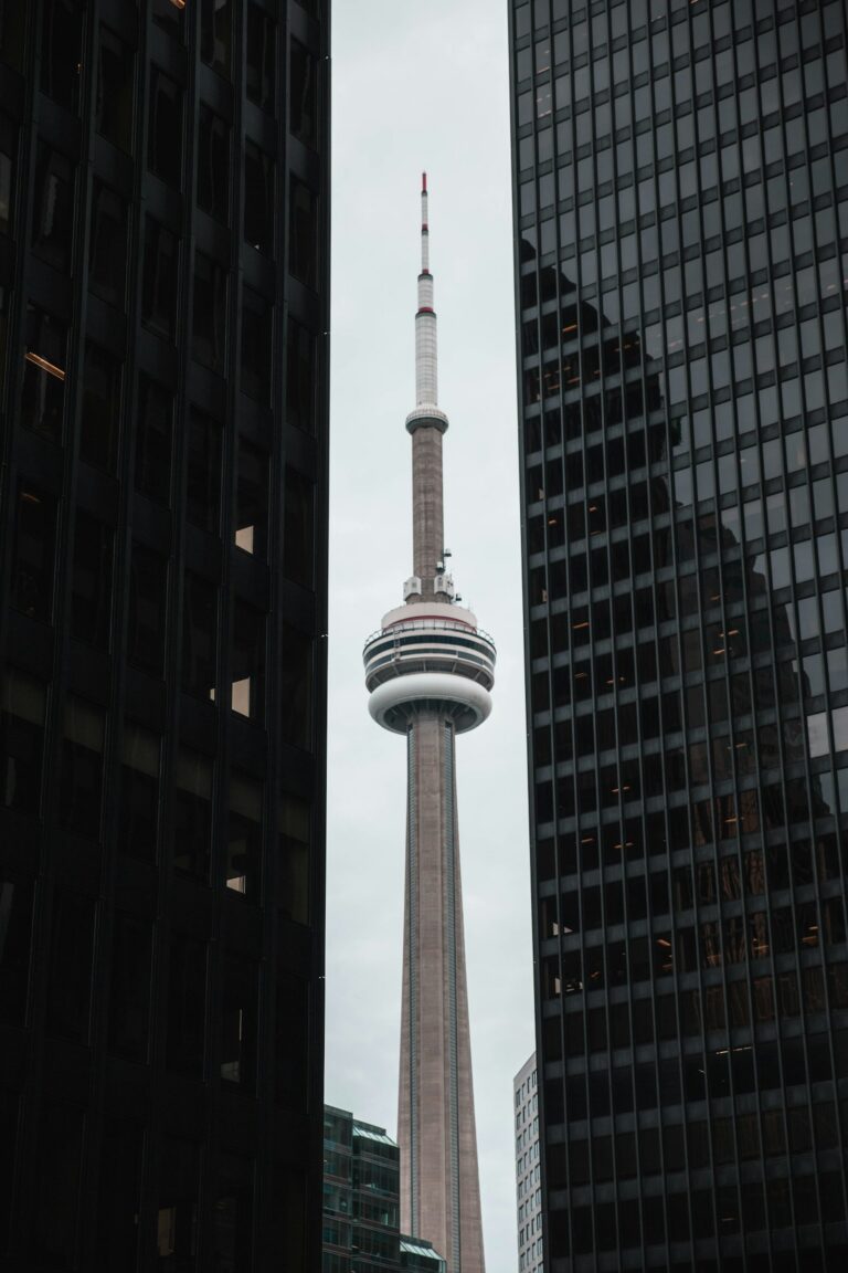 CN Tower rising above Toronto financial district skyscrapers, representing the regulatory environment for PCMLTFA AML/CTF compliance in Canada