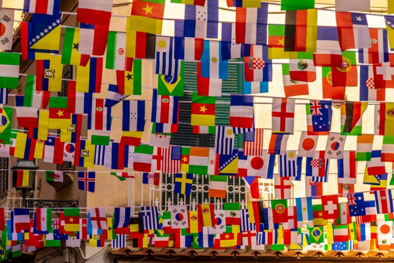 International flags of many nations displayed together, representing FATF mutual evaluation of GCC jurisdictions