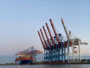 Container port with cargo cranes representing trade-based money laundering risks in Gulf trade corridors