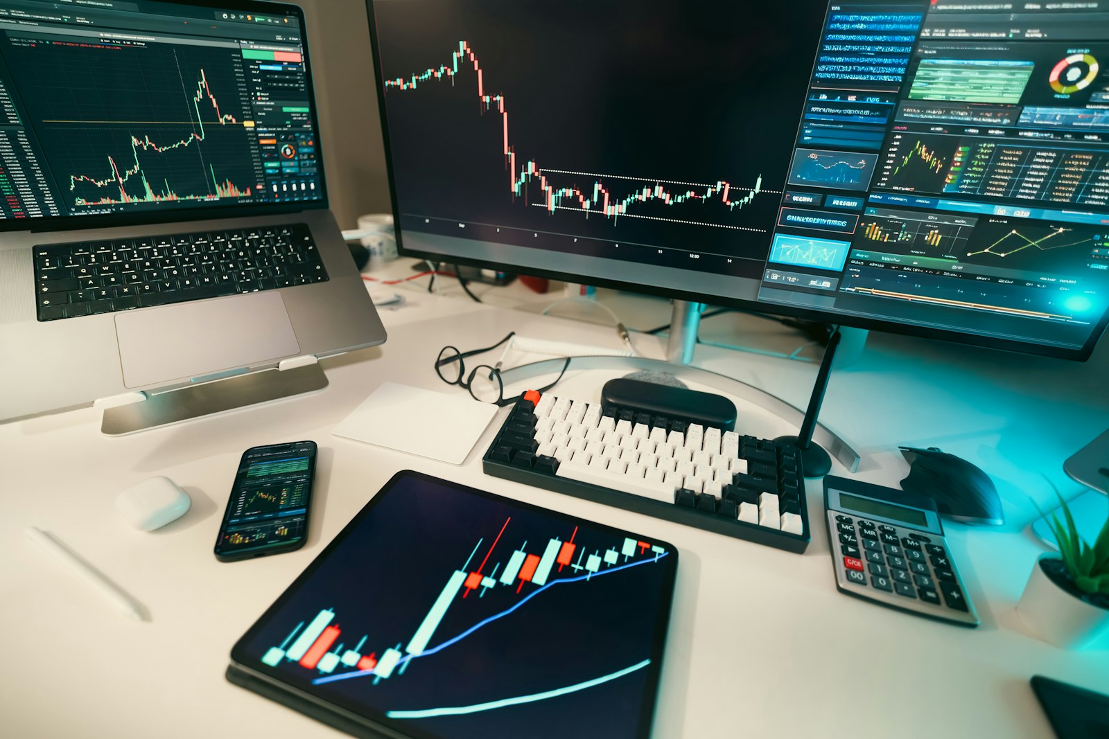 Multi-screen financial monitoring desk with dashboards displaying transaction data and market activity charts for AML compliance review